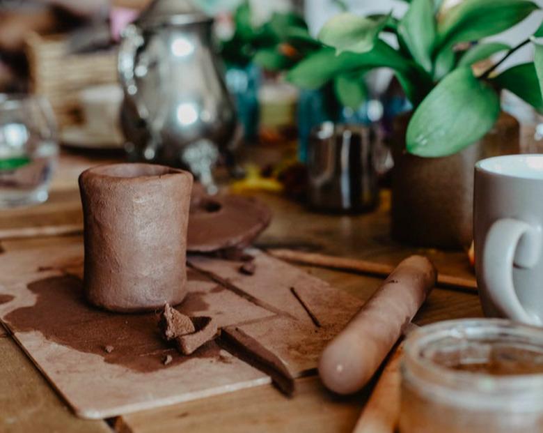 Pottery plants and mugs on a table