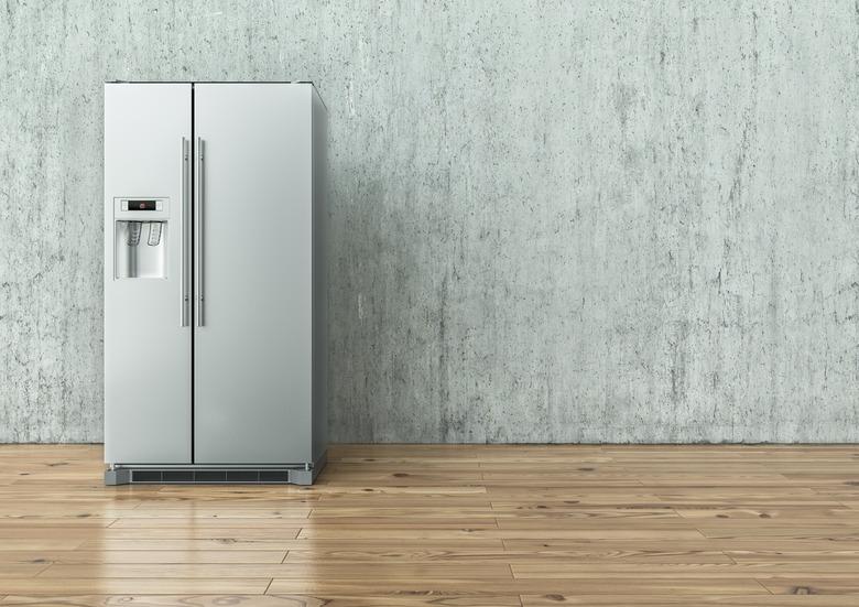 Modern Stainless Steel Refrigerator on a concrete wall and on a wooden floor - 3D Rendering