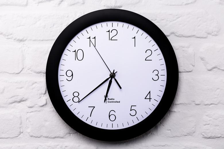 Wall clock on white brick wall