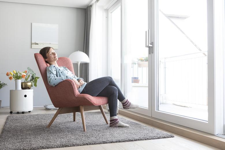 Woman relaxing on armchair at home