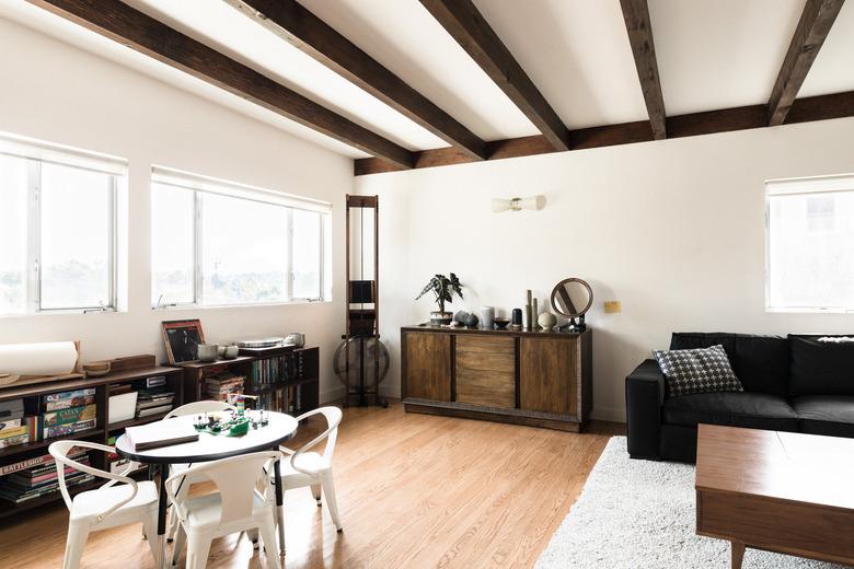 living room with media stand, couch, hardwood flooring