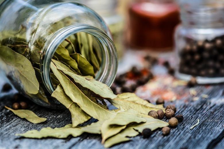 jar of bay leaves spilling onto table