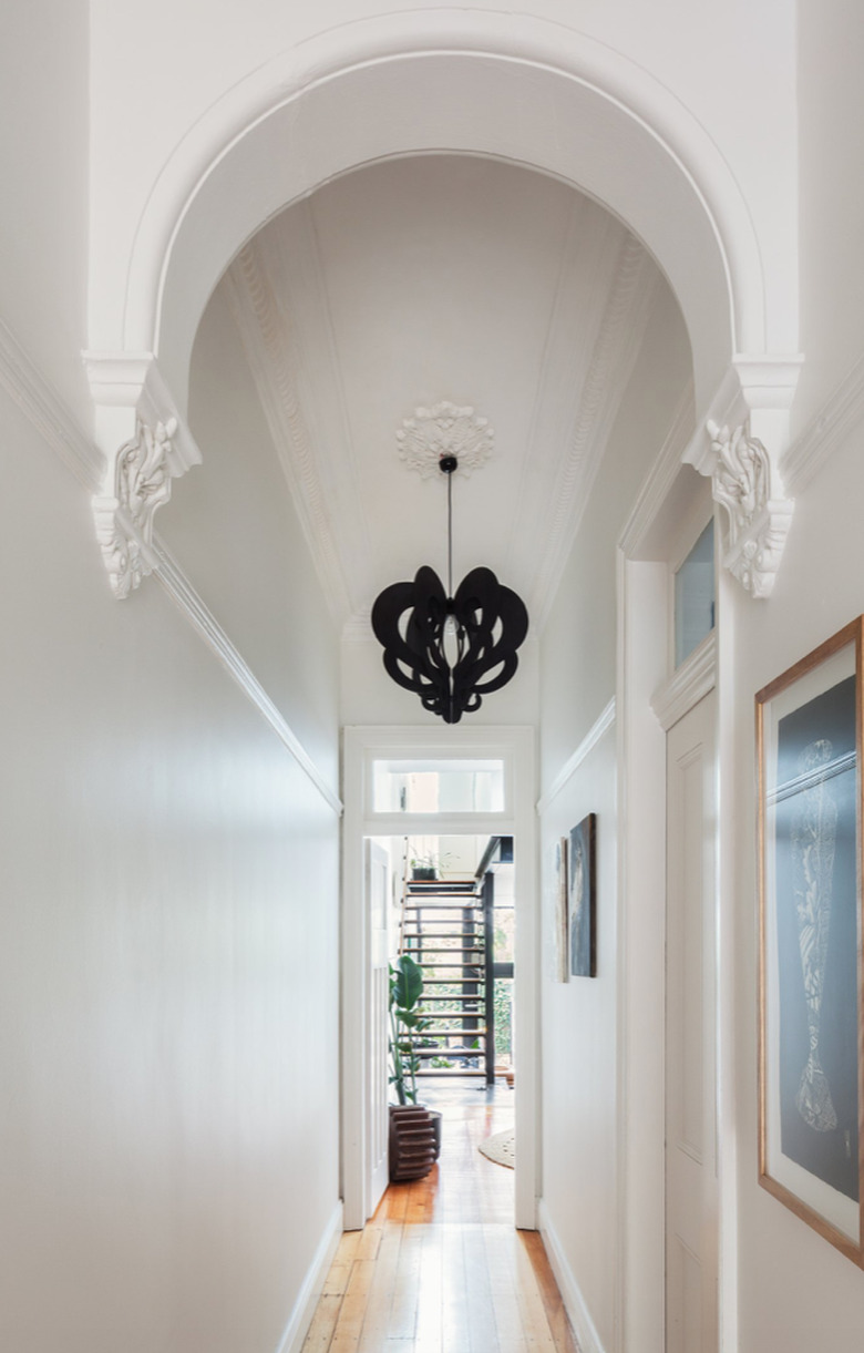 White Modern Hallway with black pendant lamp.