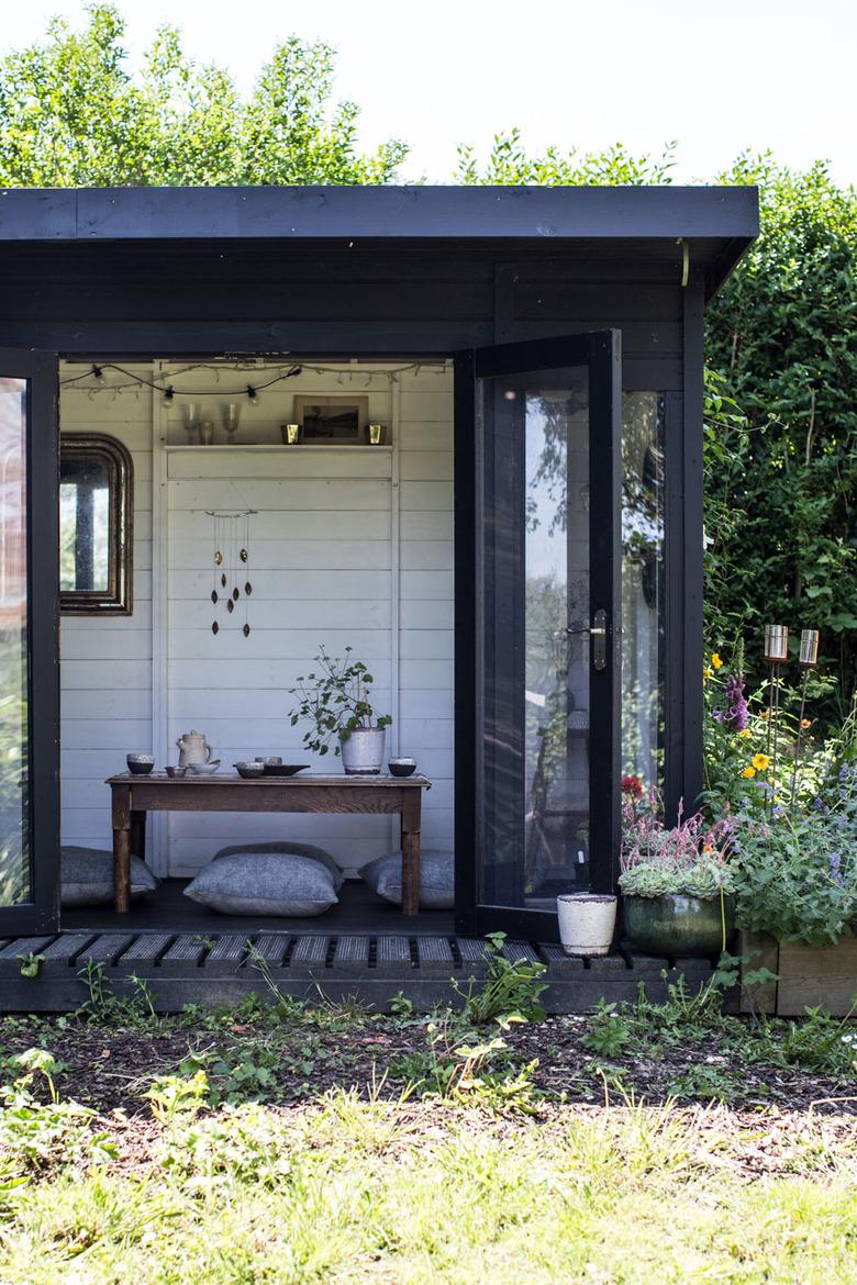 Modern shed with black exterior and French doors