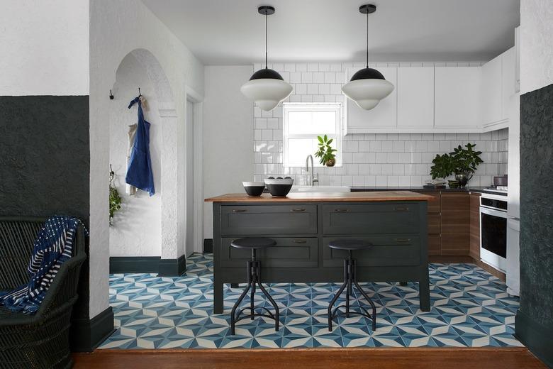 Moroccan kitchen floor tiles in blue pattern with wood cabinets