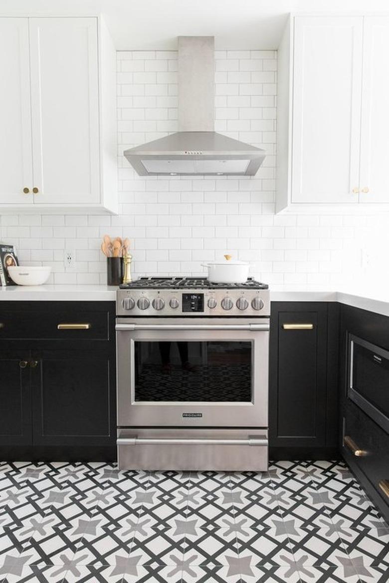 black and white Moroccan kitchen floor tiles with black cabinets and white countertops