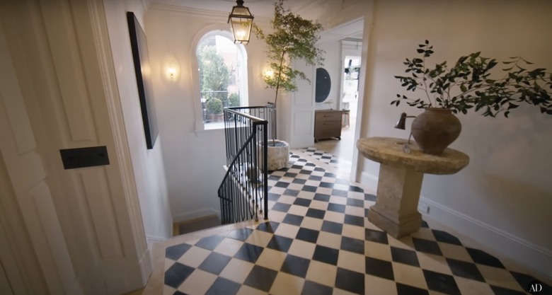 Nate Berkus and Jeremiah Brent's entryway with black and white checkerboard flooring.