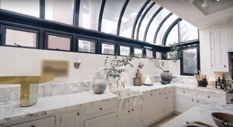 Nate Berkus and Jeremiah Brent's kitchen with large open windows that stretch from mid-wall to the ceiling.