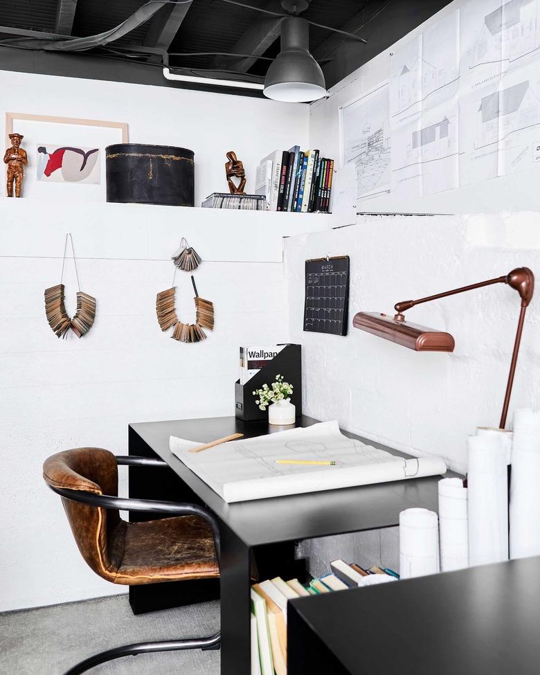 neutral home office with white walls and a leather office chair