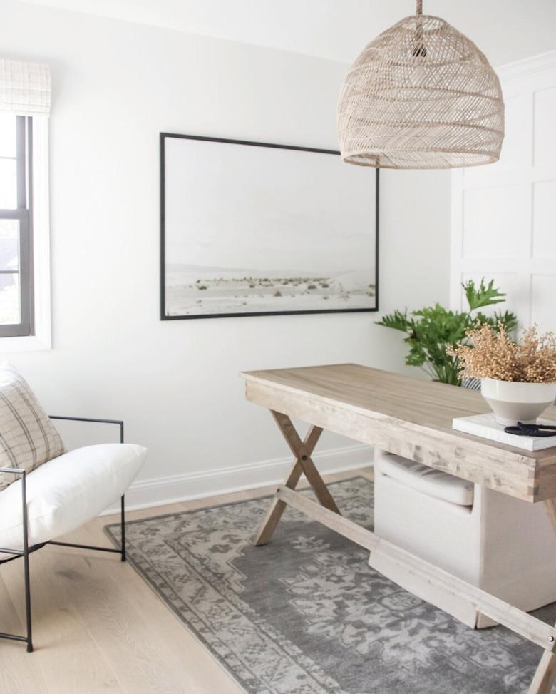 neutral home office with woven pendant light and wood desk