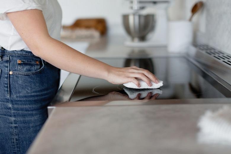 woman cleaning electric new stove