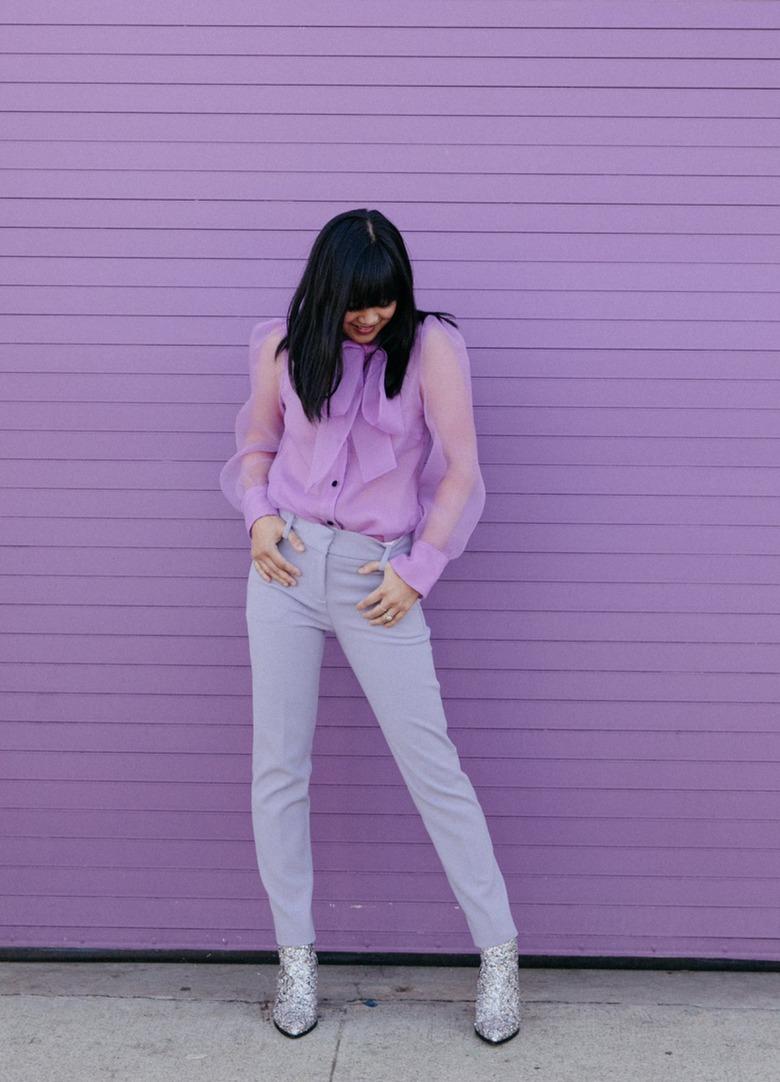 Joy Cho of Oh Joy! standing in front of purple wall