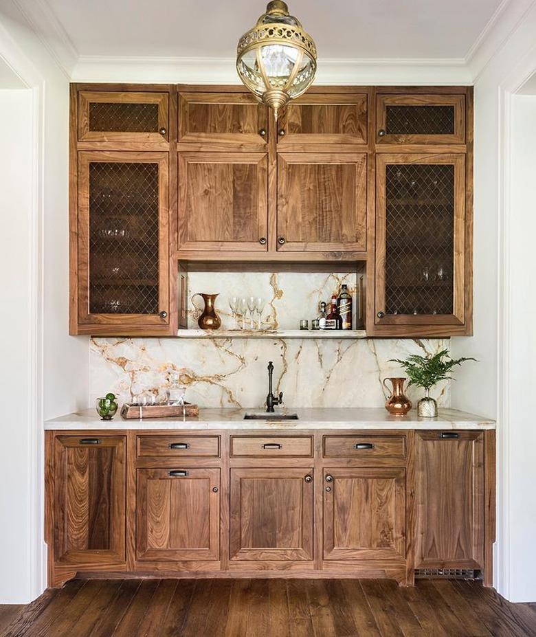 wood cabinetry with onyx countertop