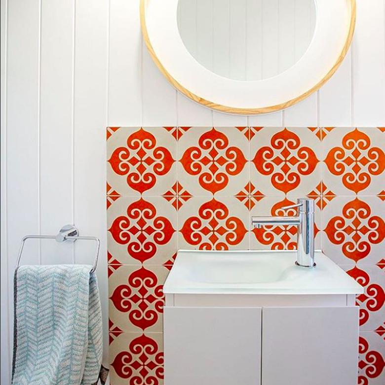 white bathroom with orange moroccan tiles