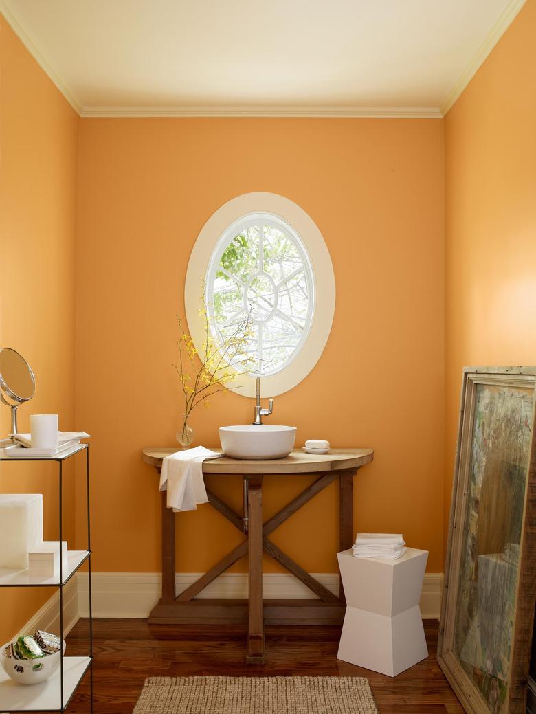 rustic bathroom with orange walls