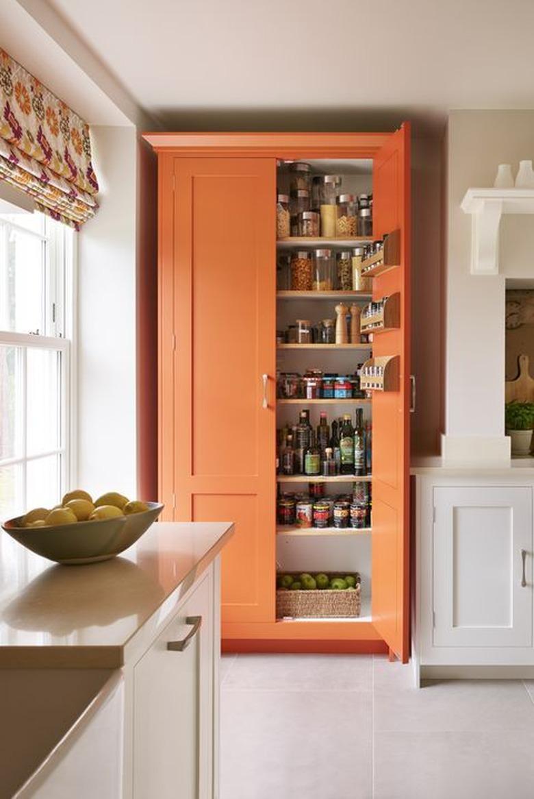 orange kitchen color idea with white shaker cabinets and orange pantry closet