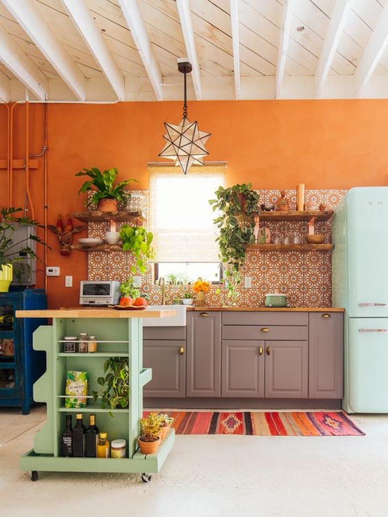 orange kitchen color idea with purple cabinetry and blue fridge