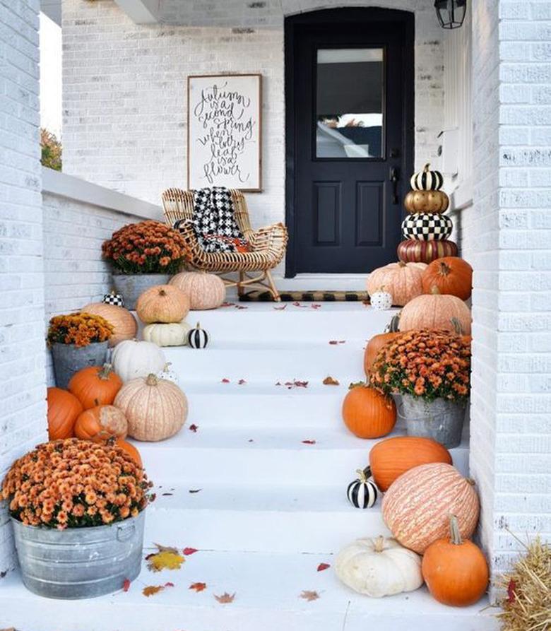 front entryway lined with pumpkins and flowers