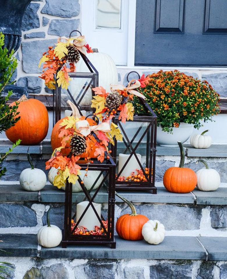 fall-inspired candle lanterns lighting front porch