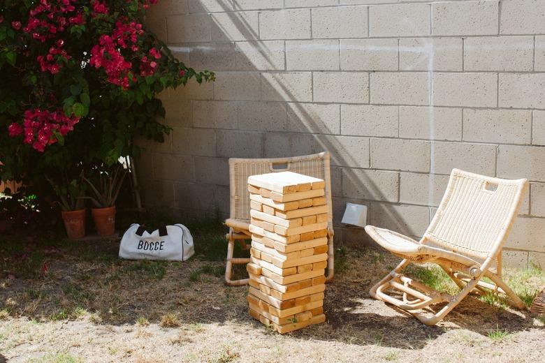 Outdoor idea with giant Jenga and patio chairs in backyard