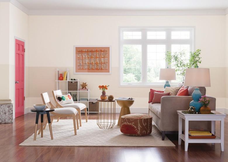 Living room with cherry wood floors and beige walls.