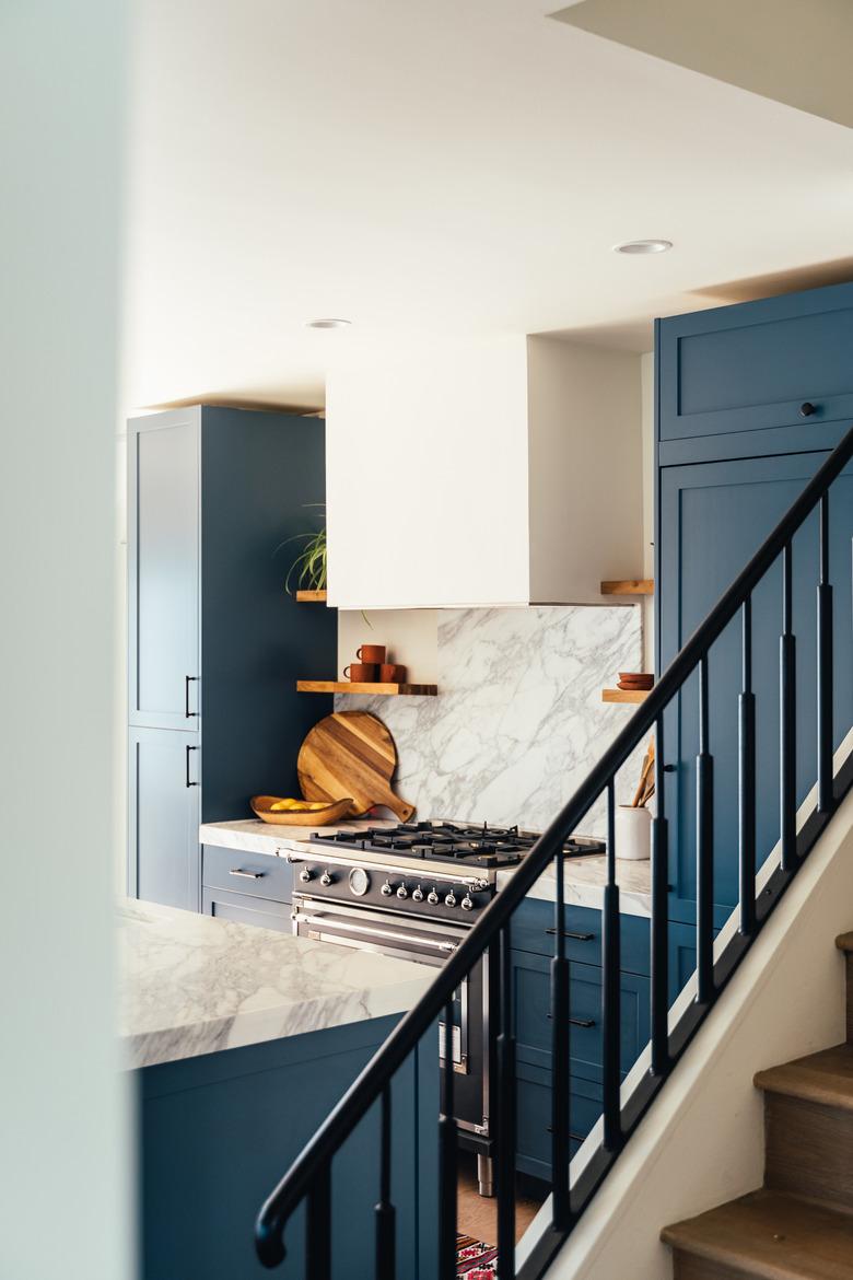 Navy blue painted stair rails in kitchen.