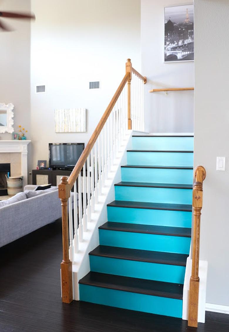 turquoise ombre painted stairs with white railing and wood banister