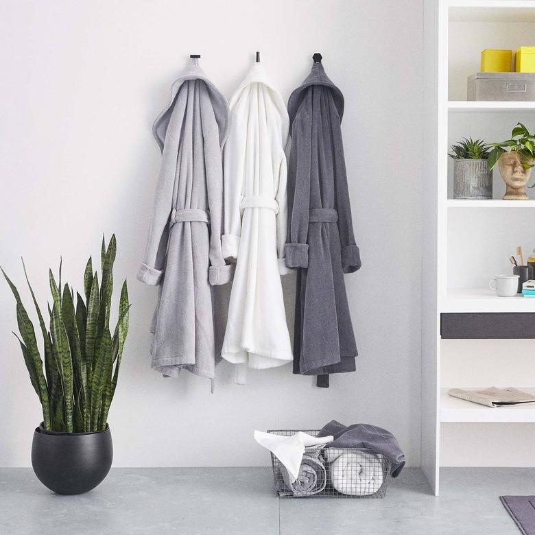 Set of three plush robes in a bathroom