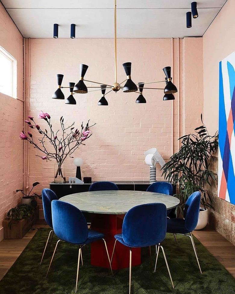 pink dining room paired with colorful accents