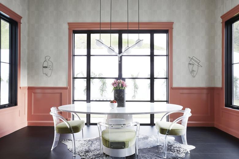 pink dining room idea with wainscoting and retro furniture