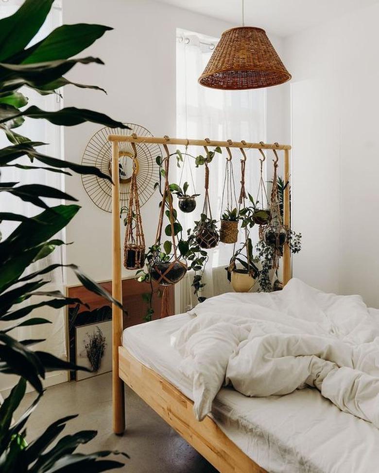 plant themed bedroom with planters hanging from IKEA bed frame