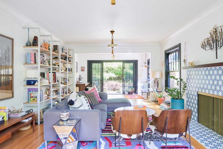 colorful living room with patterned tile fireplace