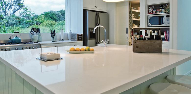 Solid white quartz countertop colors, kitchen island, kitchen island sink, built in shelves, picture window.