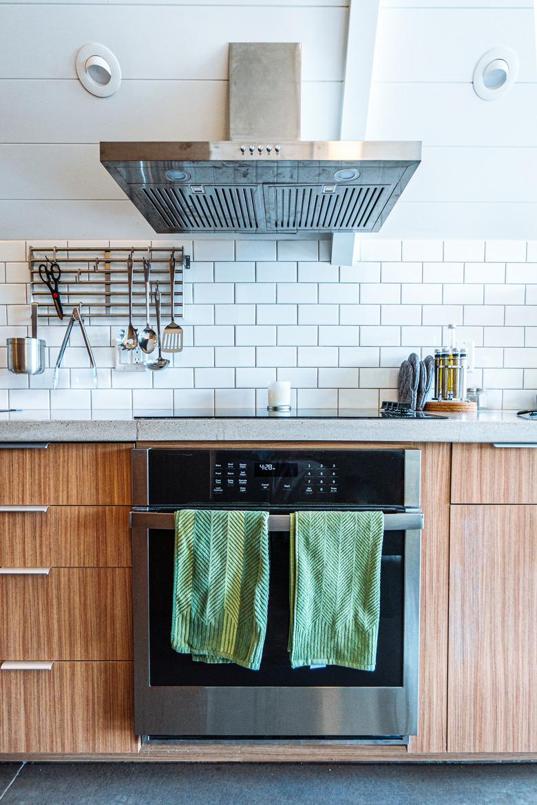 Wide Angle Shot of Green Hand Towels on the Front of a Oven and Range Stove in a Trendy Kitchen