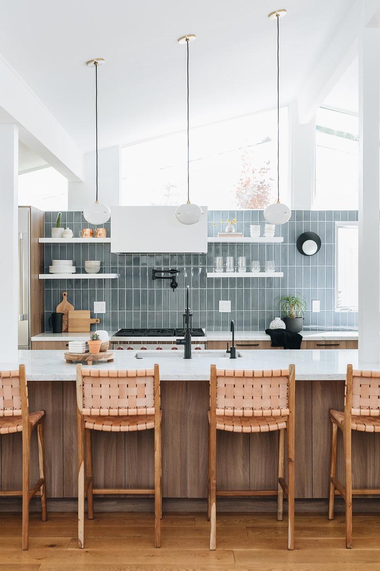 midcentury kitchen lighting idea with A-frame architecture and blue tile backsplash