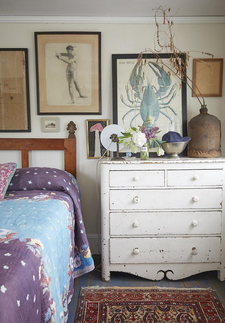 rustic beach decor in bedroom with white dresser and framed art