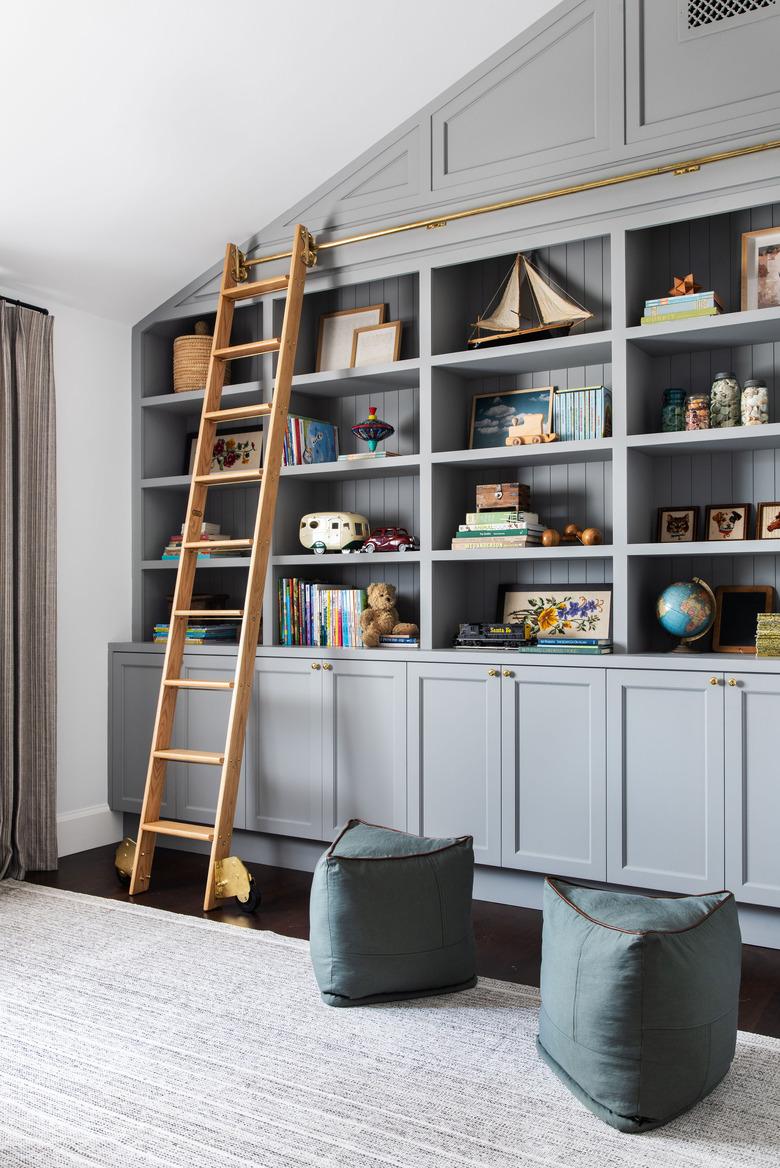 rustic beach decor in playroom with nautical toys on gray bookshelf