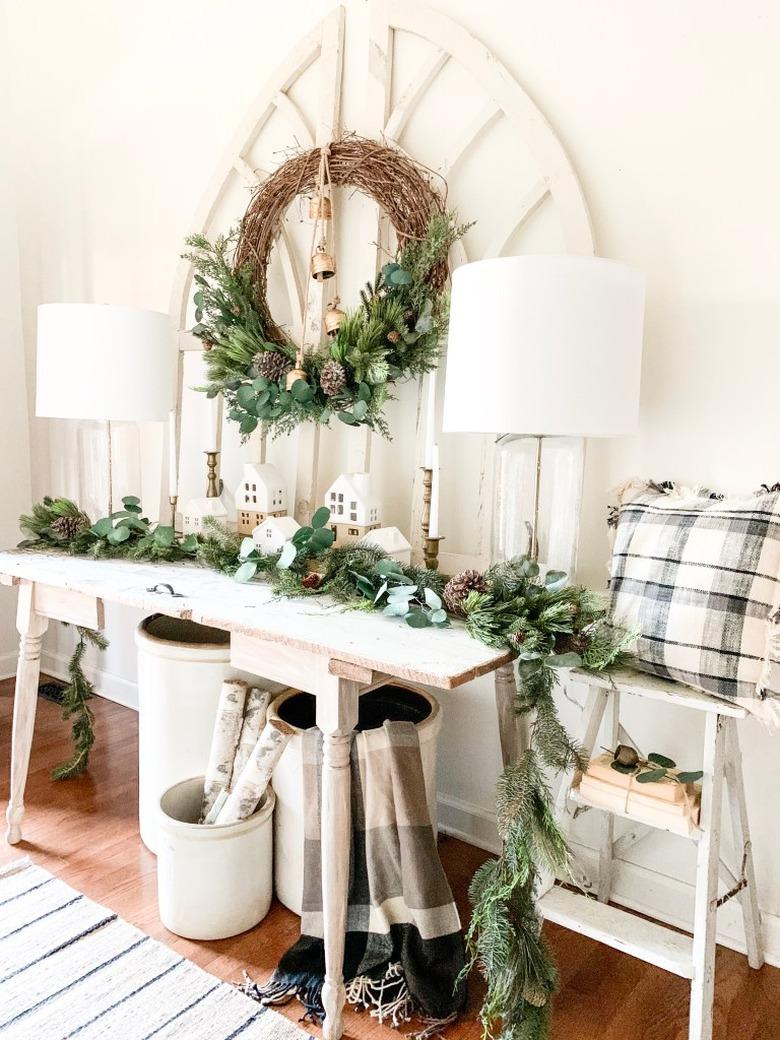 Rustic Christmas decorations in entryway with vintage pieces and winter garland