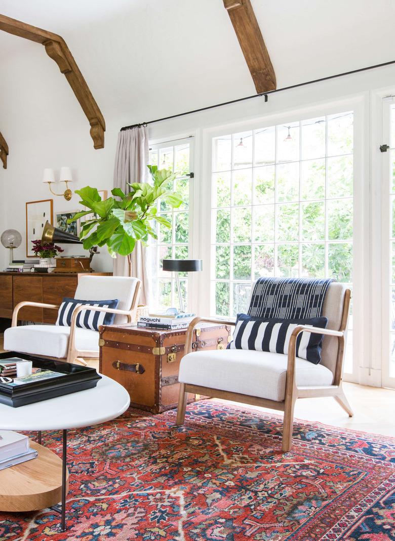 rustic family room ideas with exposed wood beam ceilings and colorful vintage rug