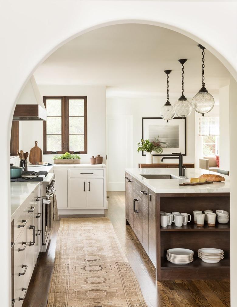 country kitchen with rustic kitchen island and three pendant lights