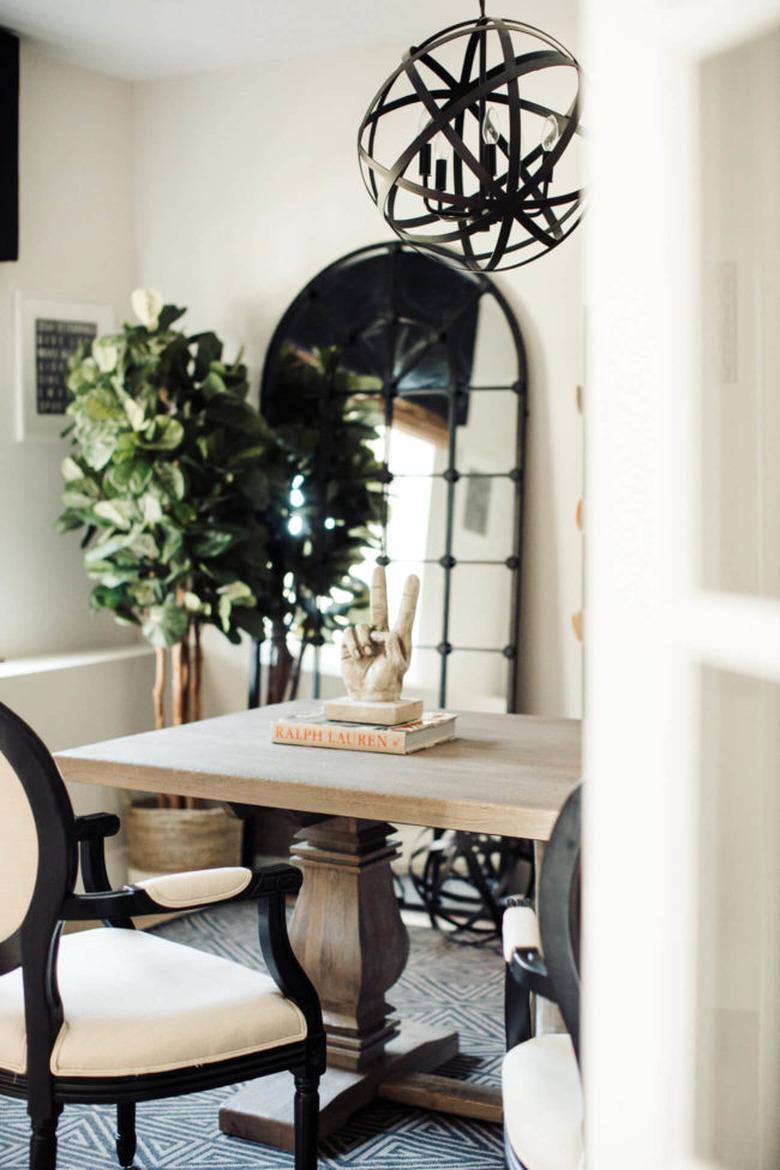 Rustic office with light wood finishes and black modern chandelier