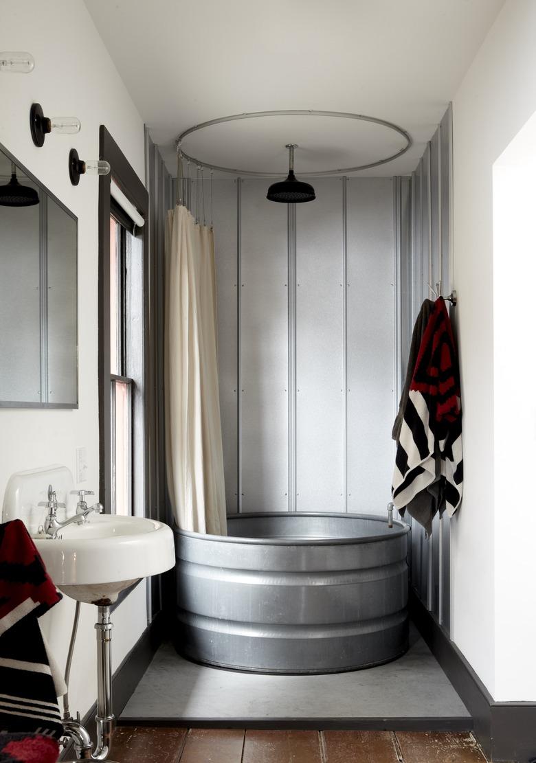 Rustic shower idea with galvanized metal bathtub and galvanized metal walls