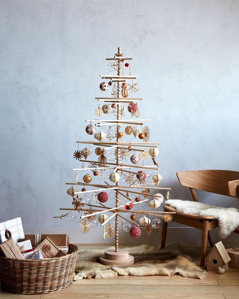 wooden dowel Scandinavian Christmas tree filled with ornaments