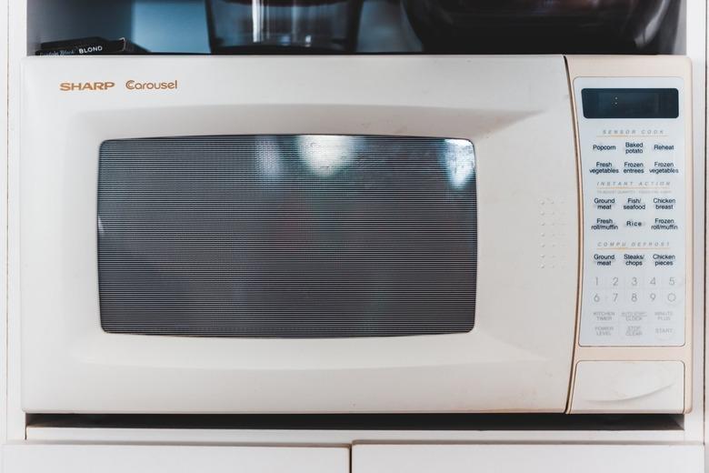 A white microwave on a white countertop