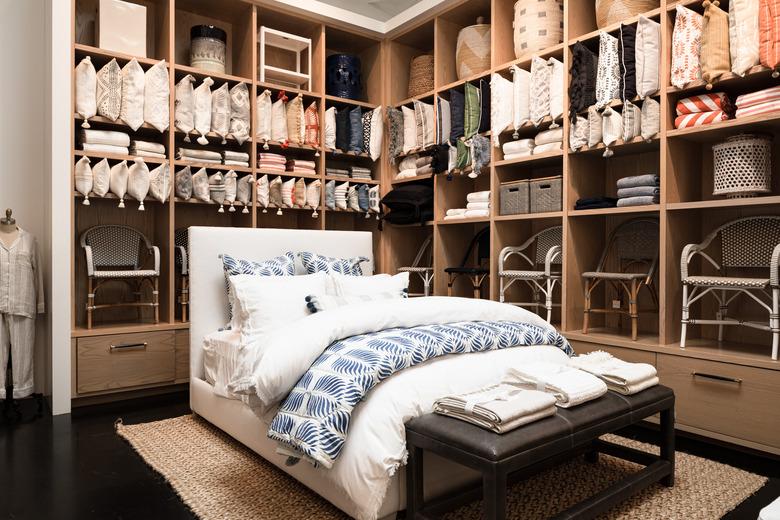 bed surrounded by shelves with decor products