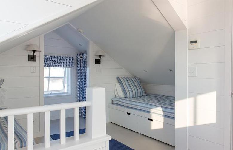 Small attic ideas with nautical decor in light blue with hard edged walls.