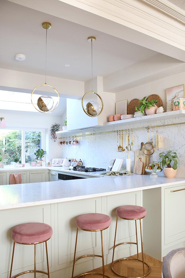 Pink and white modern kitchen with with solid surface countertops