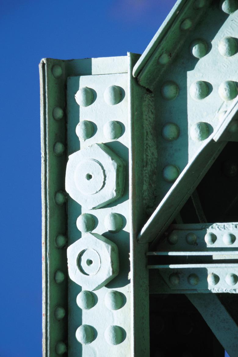 Nuts and bolts in steel girders with rivets