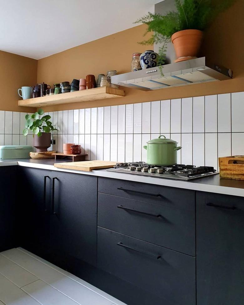 modern kitchen with black cabinets and black hardware