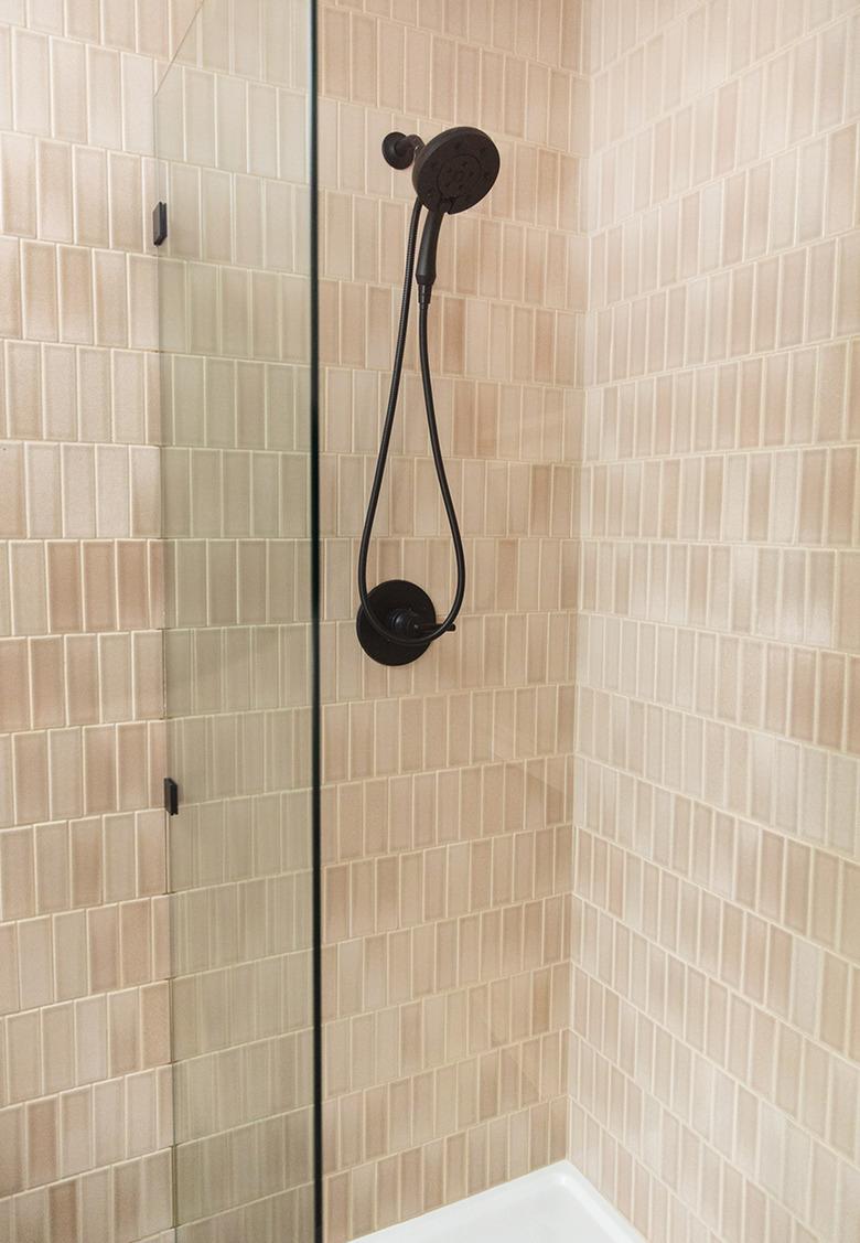 nude pink subway tile shower idea with matte black shower